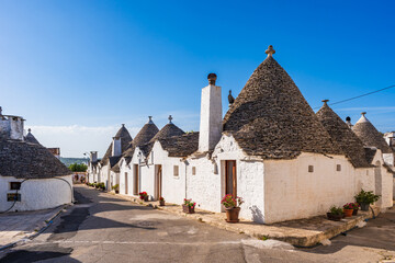 Famous traditional old dry stone trulli houses with conical roofs in Alberobello, Italy.