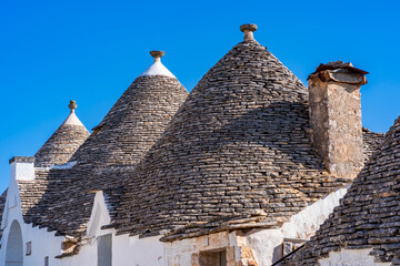 Conical roofs of the famous old dry stone trulli houses in Alberobello. Italy