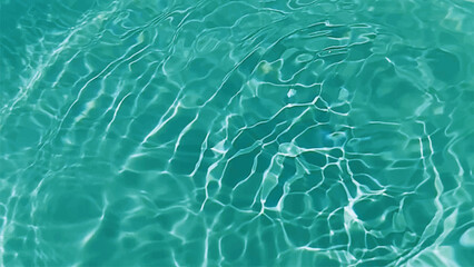 Blue water with ripples on the surface. Defocus blurred transparent blue colored clear calm water surface texture with splashes and bubbles. Water waves with shining pattern texture background.
