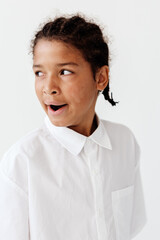 Young african american boy in stylish white shirt against clean white backdrop, exuding confidence...