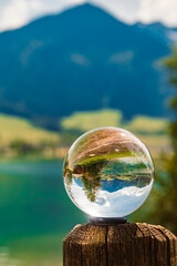 Crystal ball summer landscape shot at the famous Lake Walchsee, Kufstein, Tyrol, Austria