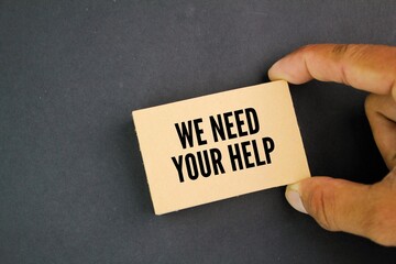 brown paper with the words WE NEED YOUR HELP. business concept