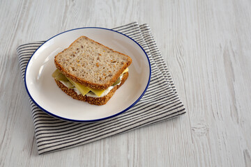 Homemade Pickle Sandwich with Mayo and Cheese on a Plate, side view. Copy space.