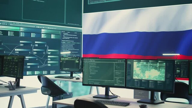 Empty autocracy cyber defense room with Russian flag running on big screen, showcasing the threat of cyberterrorism and propaganda. Activities of Russian hackers to spread fake news. Camera B.