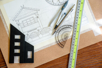 Top-view of architectural plans for building a house and miniature building models for engineering...