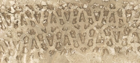 Traces from a tractor, car on the sand texture closeup. Tire tracks
