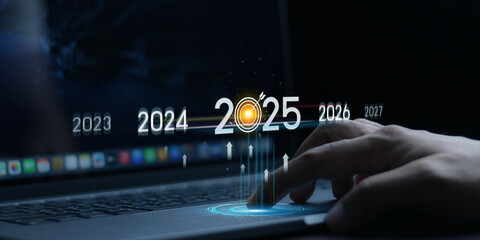 Countdown to 2025 concept. the taps a virtual download bar with a loading progress meter on New Year's Eve, turning the year 2024 to 2025.