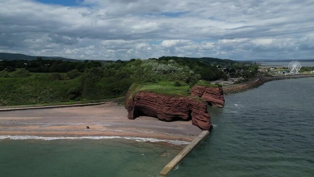 Dawlish Warren, River Exe, South Devon, England: DRONE VIEWS: Langstone Rock and Dawlish Warren funfair including a ferris wheel. South Devon is a popular UK holiday destination (Clip 1).
