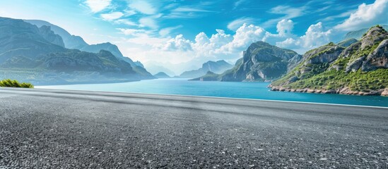 Asphalt road and mountain with blue sea natural landscape. Copy space image. Place for adding text or design