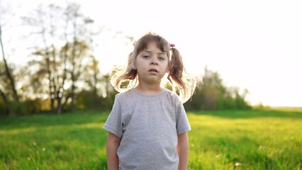 people in the park. portrait little girl outdoors. happy family kid dream concept sunlight. child a girl kid portrait close-up in the park glare. happy cute baby in summer outdoors close up portrait