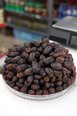 natural sweet palm dates on a plate for sale at the market