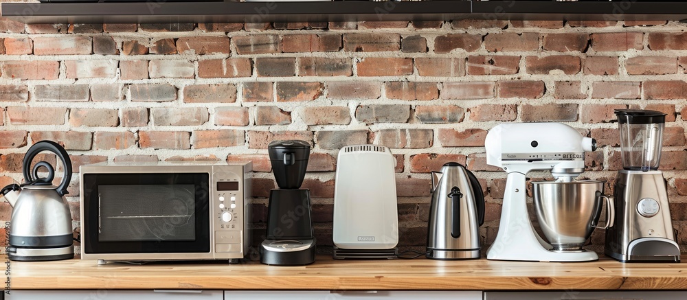 Poster household and kitchen appliances on table against brick wall background. interior element. with copy