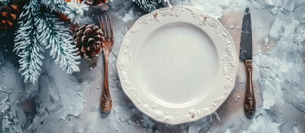 Poster christmas table place setting with christmas pine-cone and plate, knife and fork / christmas holiday