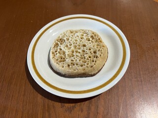 Crumpet (small griddle bread made from an unsweetened batter of water or milk, flour, and yeast)