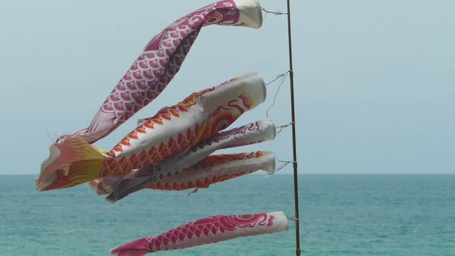 Carp Flag ( Koi no bori symbol of Japanese Boys Day ) are fluttering in the wind over the beautiful blue sky.