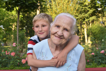 Fototapeta premium Elderly woman with her grandson in the park