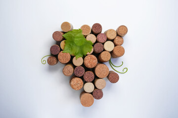 A bunch of grapes made of wine cork isolated a white background. Top view, flat lay. Festivals, holidays, traditions and winemaking concept.