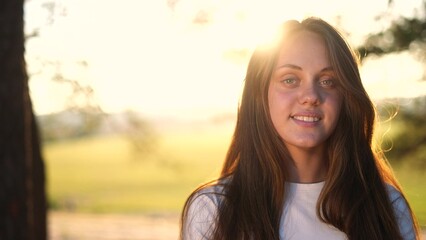 teen girl portrait in the park. close-up a girl child in nature. happy family teenager concept. happy girl smiling. cheerful teen girl portrait close-up. teenager outdoors nature in sun the park