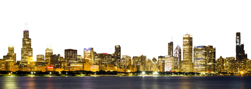 Panoramic view of the Chicago skyline illuminated at night, reflecting on water, with a white background at the edges