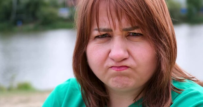 Attractive scowling angry, Head shot scowl, was offended gloomy eyebrows, Sulky, Waist-up portrait of beautiful face in displeasure, affront tensed, having bad mood, getting mad, frowning forehead