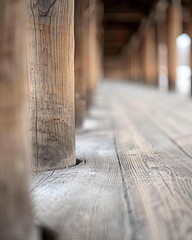 Close-up of wooden posts and floorboards, creating a perspective of depth and age.