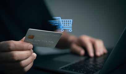 Man use labtop with online shopping digital cart with credit card for shopping payment online with application.Intelligent E-commerce,internet banking payment,financial technology. lifestyle.