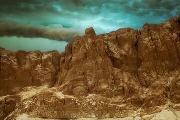 Scenic view of a rocky, rugged landscape with a dramatic sky above it