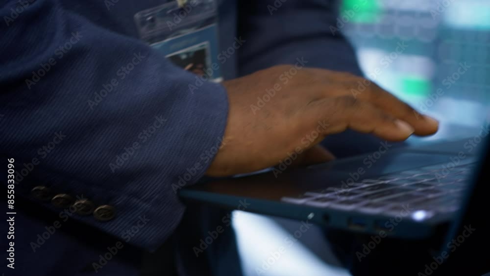 Poster it technician working on notebook in data center, overseeing server operations. extreme close up sho