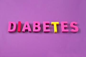 Colorful word Diabetes on pink background. Horizontal imagecwith copy space.