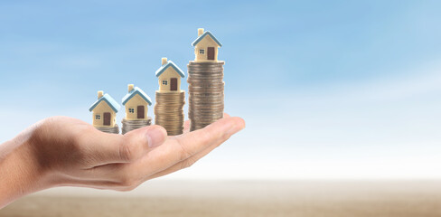 Hands and stock coins and model house ,money saving ,Business idea