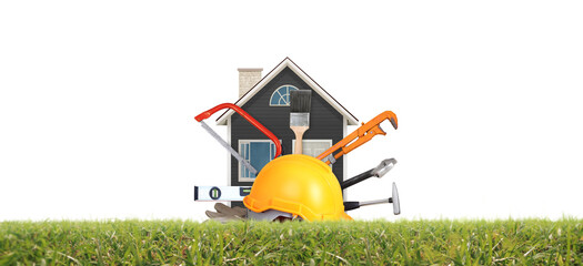 Yellow hardhat and old leather gloves and model house grass as fokaw