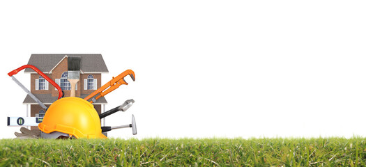 Yellow hardhat and old leather gloves and model house grass as fokaw