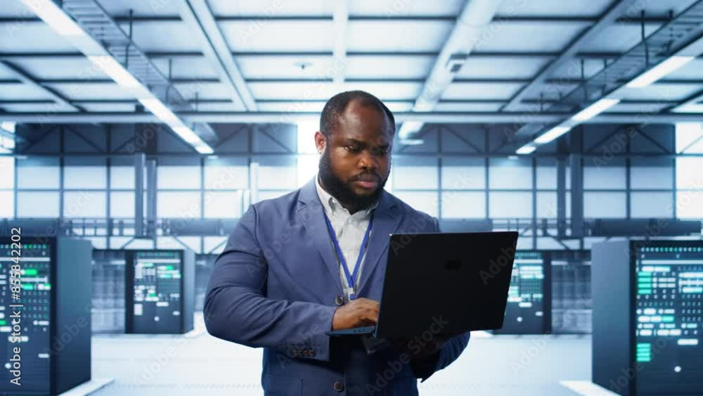 Poster computer scientist in data center using diagnostic tools and system monitoring software on laptop to