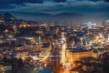 The picturesque cityscape of Sarajevo bathed in the soft glow of twilight invites travelers to explore its historic landmarks and immerse themselves in its captivating atmosphere.