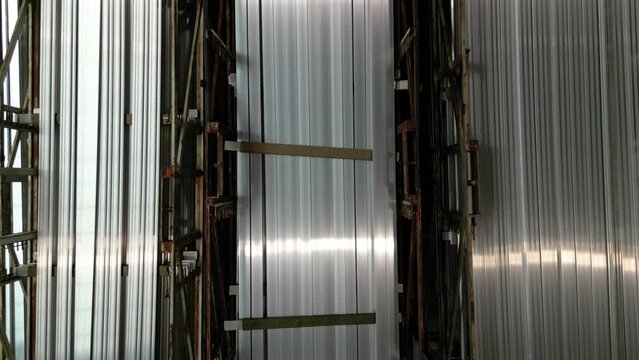 Industry business production and heavy metallurgical industrial products, many shiny aluminium profiles, industrial background, manufacturing business production concept in factory warehouse.