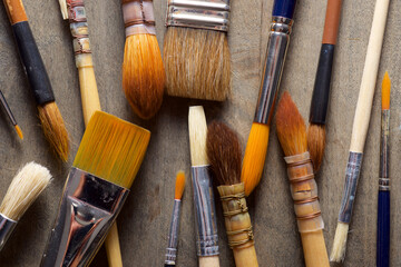 Fototapeta premium Group of artist paintbrushes on a wooden workbench