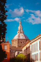 Fototapeta premium View of the dome of Pavia Cathedral among the city's houses and buildings, vertical