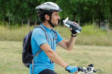 male cyclist during break in forest