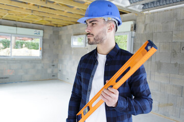 a builder on site with spirit level