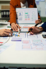 UX developer and ui designer brainstorming about mobile app interface wireframe design with...