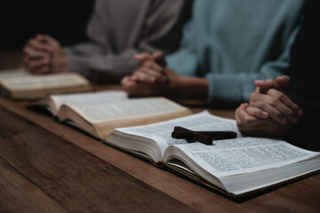 Asian men and women hands praying to god with the bible. Pray for god blessing. Religious beliefs Christian life crisis prayer to god.