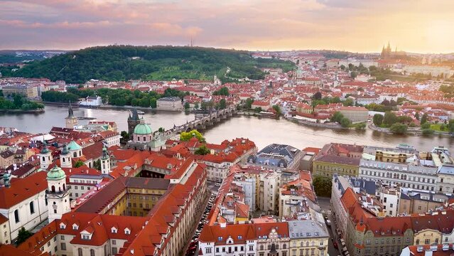Aerial summer sunset view over the rooftops of the old town of Prague, Czech Republic, towards the Charles Bridge and Castle at Lesser town