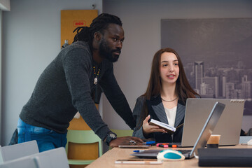 Fototapeta premium A Business Adult Man and Woman are looking towards the whiteboard in front while working together