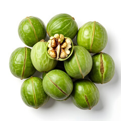 Green and ripe walnuts against a white background