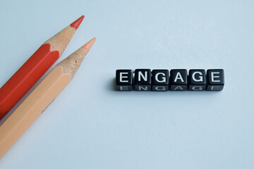 Concept of Engage written on wooden blocks. Cross processed image on Wooden Background