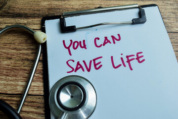 Concept of You can save life write on paperwork isolated on wooden background.