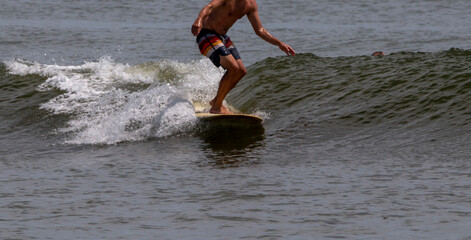 Front view of one man surfing off the coast of Long Island