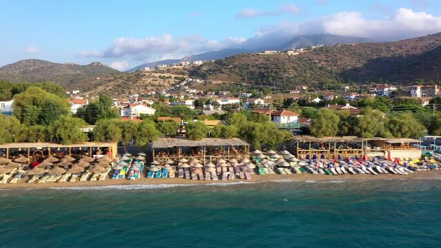 Panoramic view. Seaside resort of Palamutb&uuml;k&uuml;. Looking from the sea over the beach to village. Hotels, cafes, holiday camping areas can be seen among the almond trees. Dat&ccedil;a, Muğla, Turkey