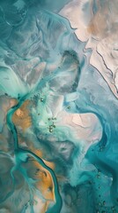 Aerial view of abstract natural patterns with green and blue water flowing through sandy landscapes, creating unique artistic shapes.