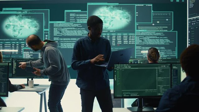 Cyber investigation team working in a governmental hacking room, working on computer security and phishing detection. Emphasizing online security, digital threats and malware prevention. Camera B.